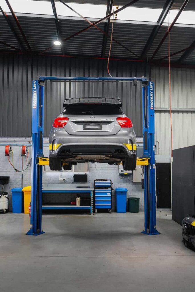 A Mercedes car on a rotatory lift ready for service by a Mercedes Mechanic Perth
