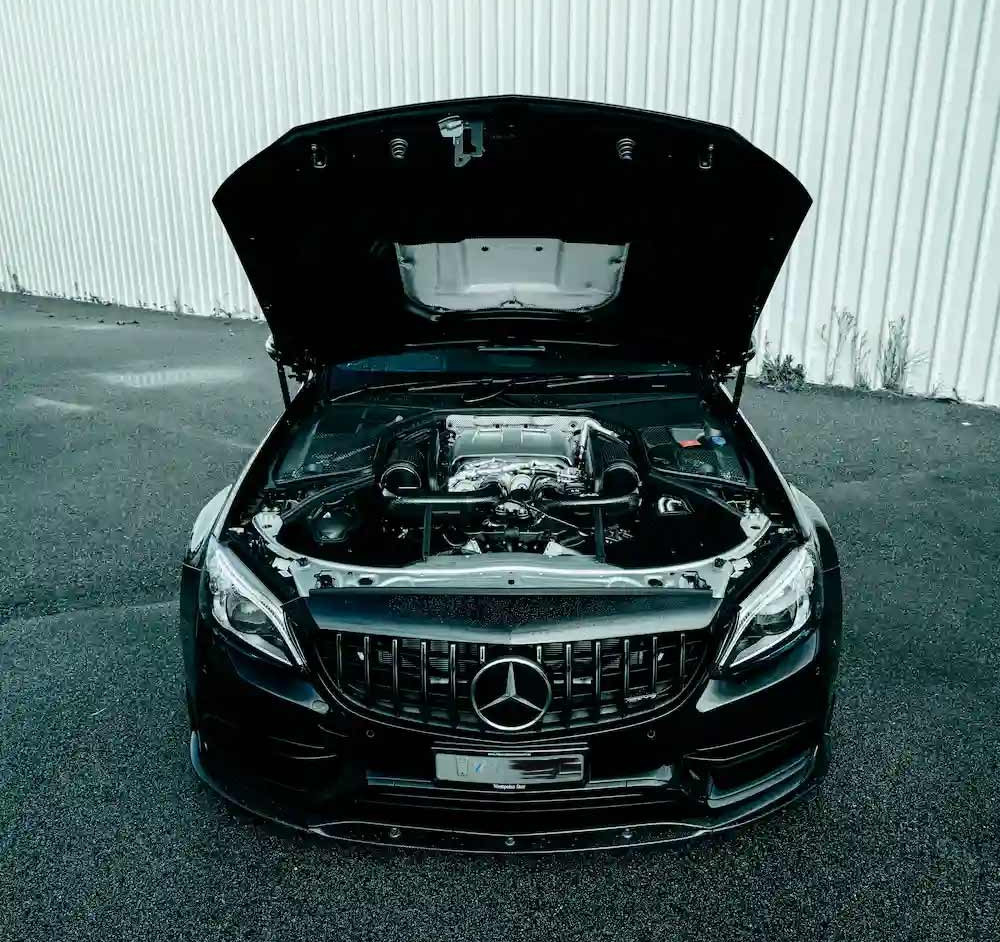 A Mercedes with engine hood open receiving a specialist service by MB Star Mercedes Servicing in Perth's Balcatta workshop.